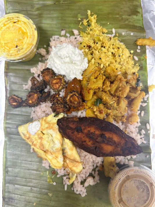Pothichoru  (Rice, cabbage Thoran, Chinese potato, fish fry, omelette, chammathi, Tender Mango pickle, kondattam & wheat Payasam)